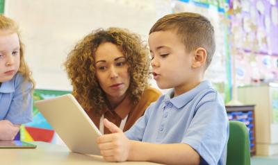 Teaching helping a student with a task in the classroom