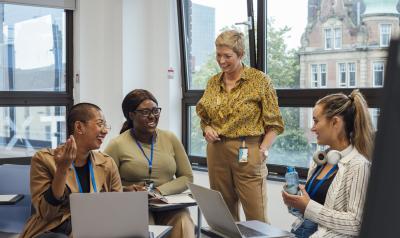 Teachers meeting with each other in a classroom