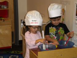 children play baking in classroom