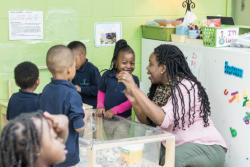 Teacher smiling with her preschool class