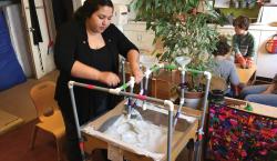 Preschool teacher building play center