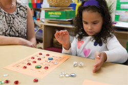 Girl playing with mathematical board game