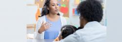 Teacher speaking to a parent and a child