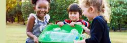 Group of children with a recycling bin