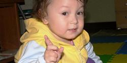 Toddler signaling with a pointer finger to wait