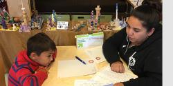 Nadia Jaboneta working with a boy at a desk