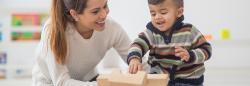 Mother and toddler son playing with blocks