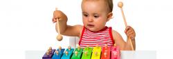 Toddler playing with a music toy.