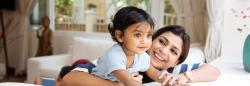 Mother holding and laughing with baby girl