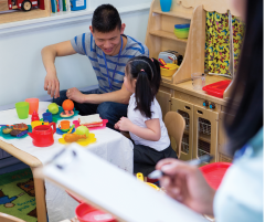 Teacher playing with student during center time