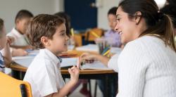 Teacher helping student count with his fingers