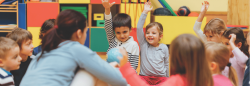 Children raising their hands in a classroom