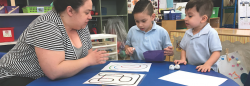 Teacher and students playing game with materials