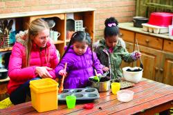 Children playing with kitchen utensils outdoors