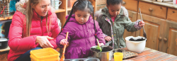 Teacher and students with mud kitchen