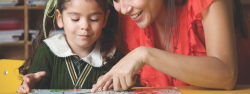 Teacher and child reading a book