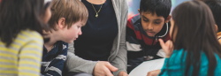 Teacher and students discussing a book