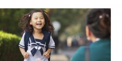 Early childhood girl smiling as she greets someone