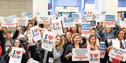 a group of people holding up signs that say "I love ECE"