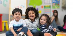 A group of three happy children.