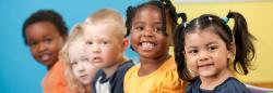 Three girls and two boys smiling for a picture