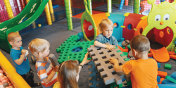 Children work together to build with toys.