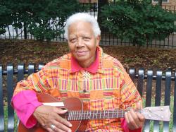 Ella Jenkins playing a guitar