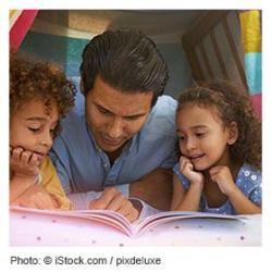 Father reading to son and daughter