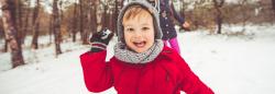 Young boy throwing a snow ball outside