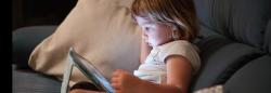 Preschool girl watching a digital tablet