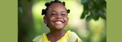 Preschool girl smiling outside