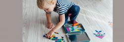 Young boy playing with shapes on the ground