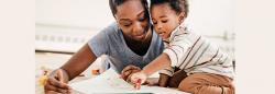 Toddler and mother reading a book 