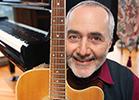 Raffi holding a guitar