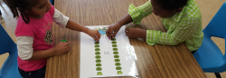 Two girls playing with lily pad math game 