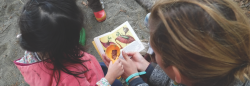 Teacher and student at a preschool in the park