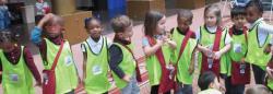 Line of small children wearing safety vests