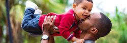 Dad embracing toddler