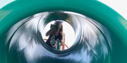 A child looking into a slide.