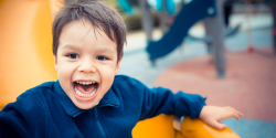 an excited child on a playground