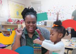 Teacher helping a young child build with magnatiles