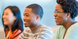Three students in a higher education classroom