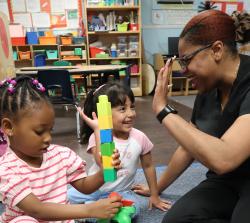 A teacher playing with students in the classroom