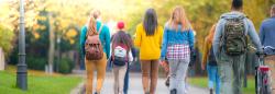 Back view of college students walking on campus