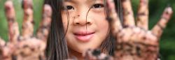 Girl with mud on hands