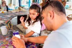 An educator and a student working on an art project together