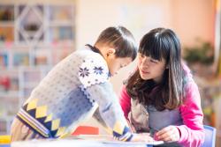 Two children working on a project in their classroom