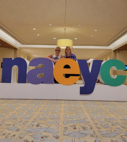 NAEYC members standing behind the NAEYC letters at Annual Conference