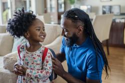 A father and daughter getting ready for school