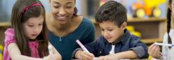 Teacher helping students to write